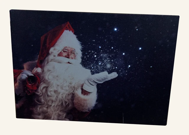 Actual small Santa canvas with a white beard, red hat and points of light against a dark blue background