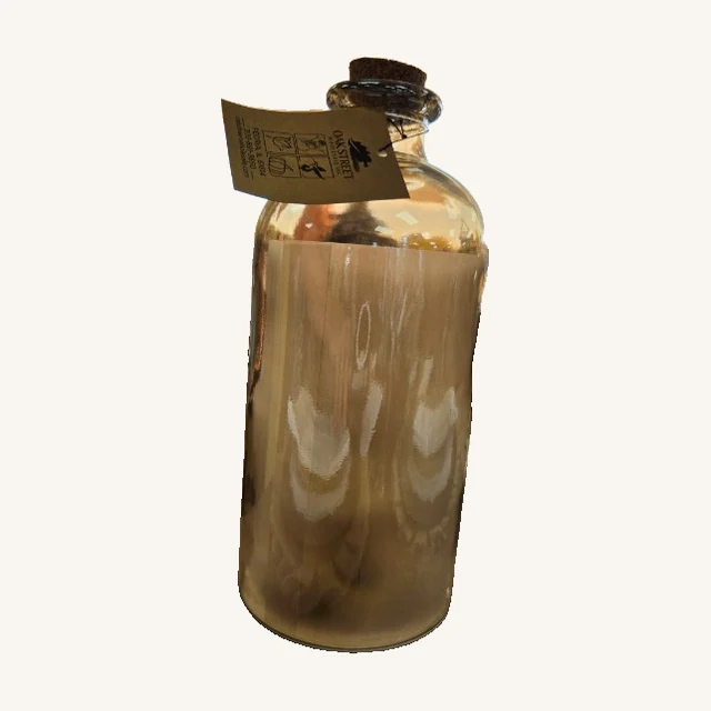 Spinning Stars Decorative Glass Jar. Swirling glass patterns and a cork top give this decorative jar a warm, softly reflective look.