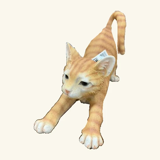 Stretching orange tabby cat figurine with curved tail, visible paws and its original hang tag.
