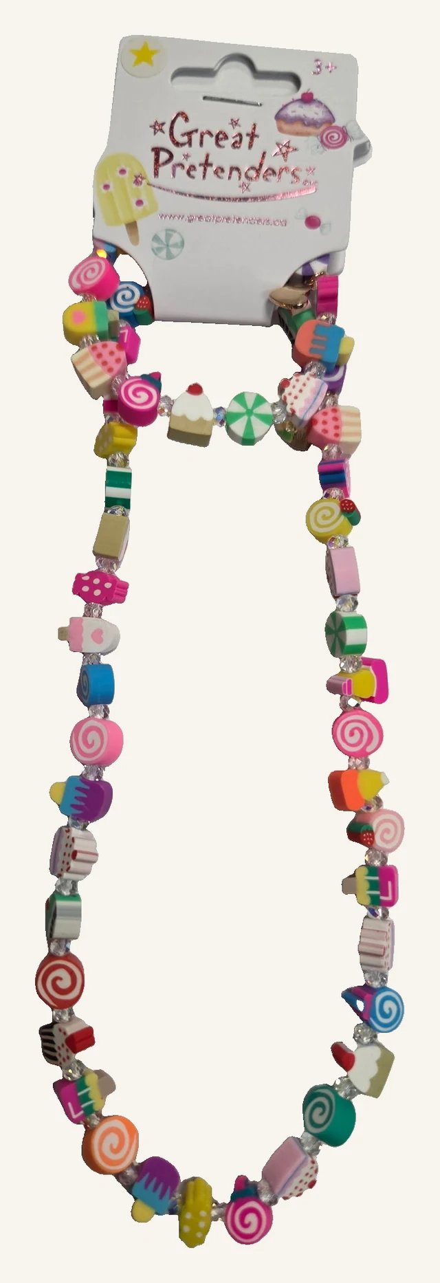 The actual complete Sweet Treats necklace and bracelet set with colorful candy, cupcake and ice-pop shaped beads on its original display card.