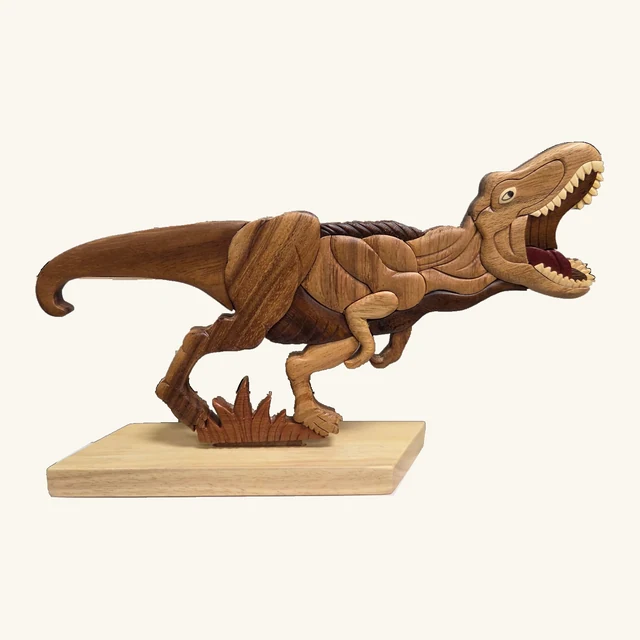 T-Rex table decoration with open mouth, pale teeth, long curved tail, contrasting grain patterns, and a rectangular base.