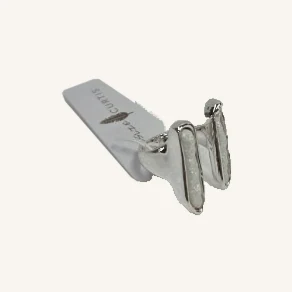 Tanner open silver-tone ring with its actual two elongated white resin stones and Leslie Curtis tag