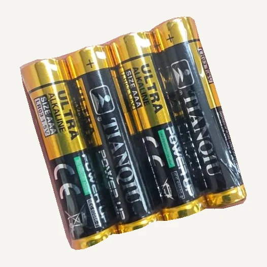 Four gold-and-black TIANQIU Ultra AAA alkaline batteries grouped together in clear wrapping