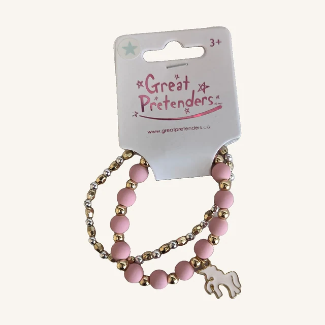 Unicorn Dreams two-bracelet set with pink beads, gold- and silver-toned beads and a white unicorn charm on the complete retail card.