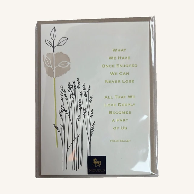 NIQUEA.D sympathy card with delicate botanical artwork and the Helen Keller sentiment beginning What We Have Once Enjoyed, in its clear sleeve.