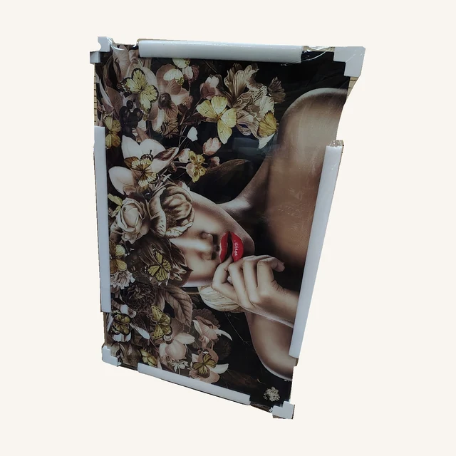 Woman with Flowers Wall Art. Flowers and butterflies frame a quiet portrait, bringing a romantic focal point to a bedroom or sitting room.