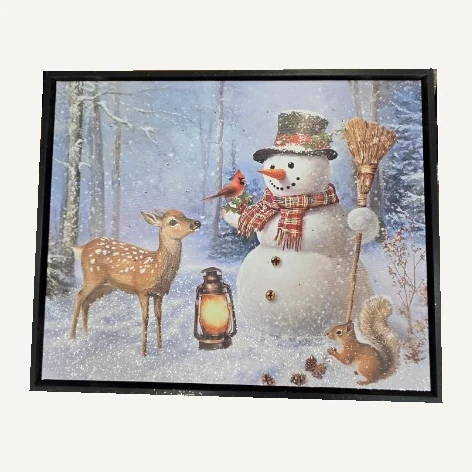 Black-framed Woodland Gatherings canvas showing a snowman, deer, squirrel, cardinal and lantern in a snowy forest
